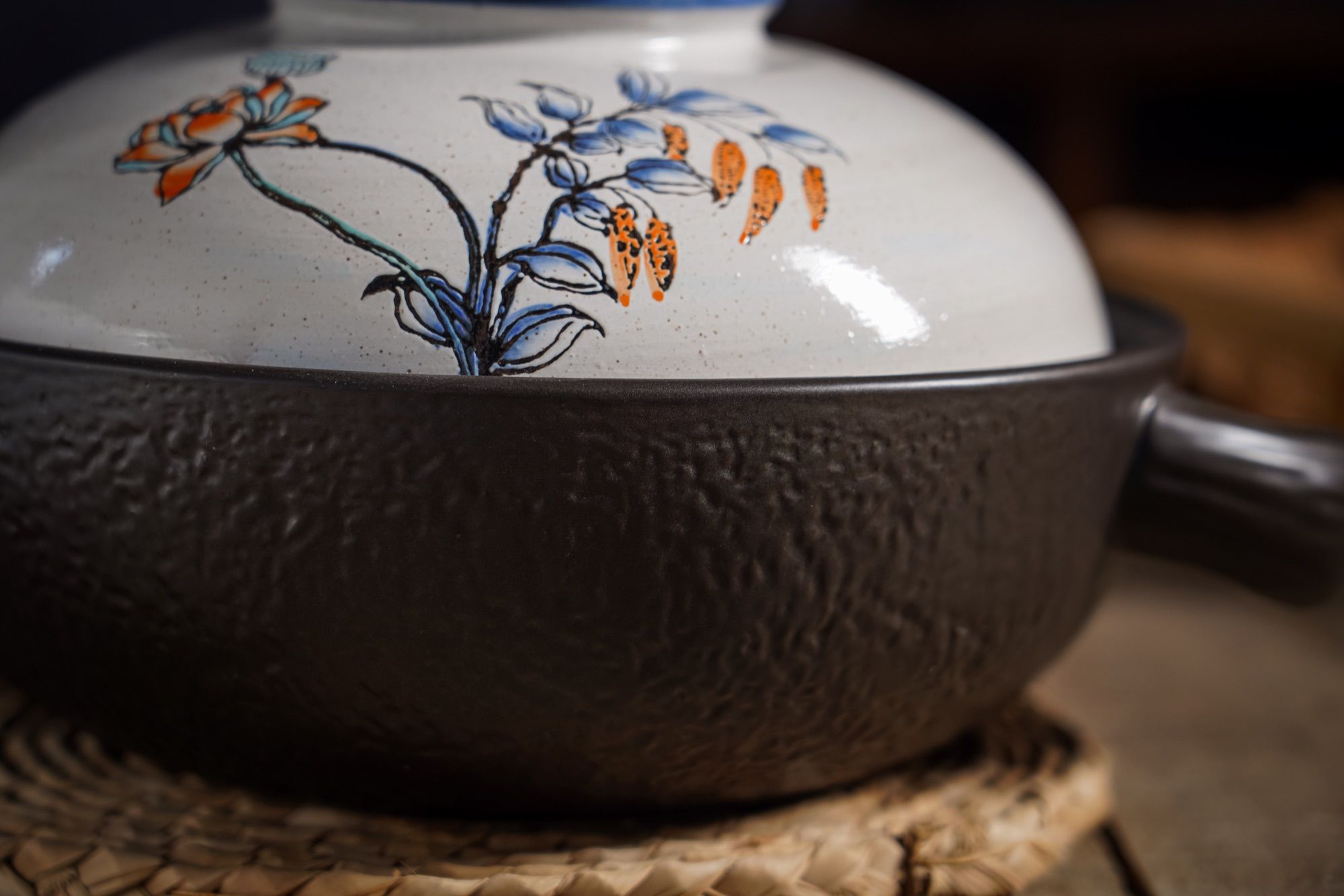 Close-up of the textured surface of a dark ceramic casserole body.
