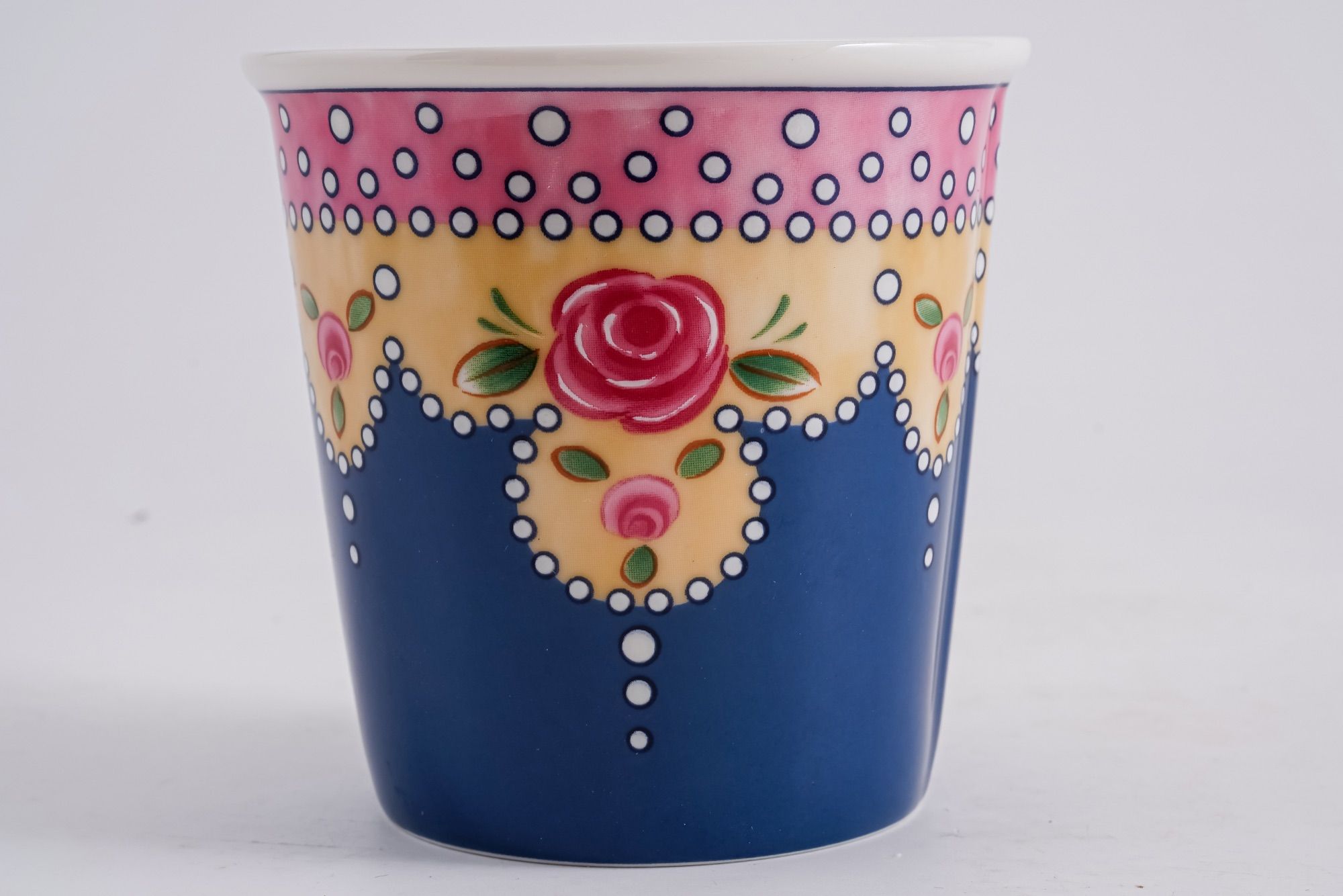 Close-up of a decorative floral pattern and ornamented rim on a cup.