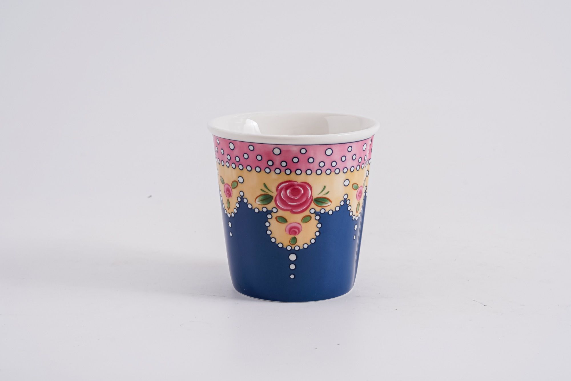A patterned handleless cup photographed against a plain white background for range review.