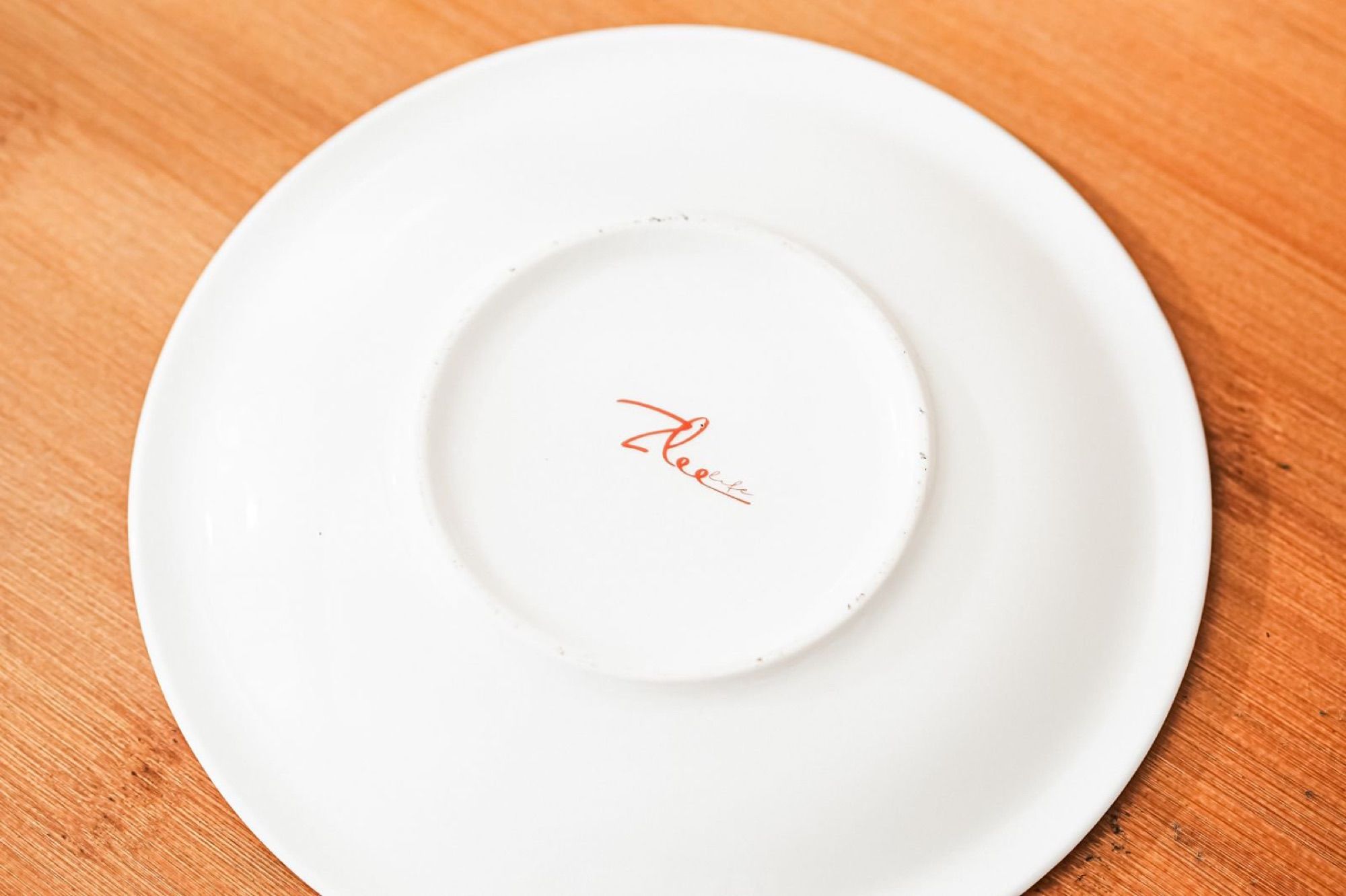 Underside of the ceramic saucer showing the back stamp.