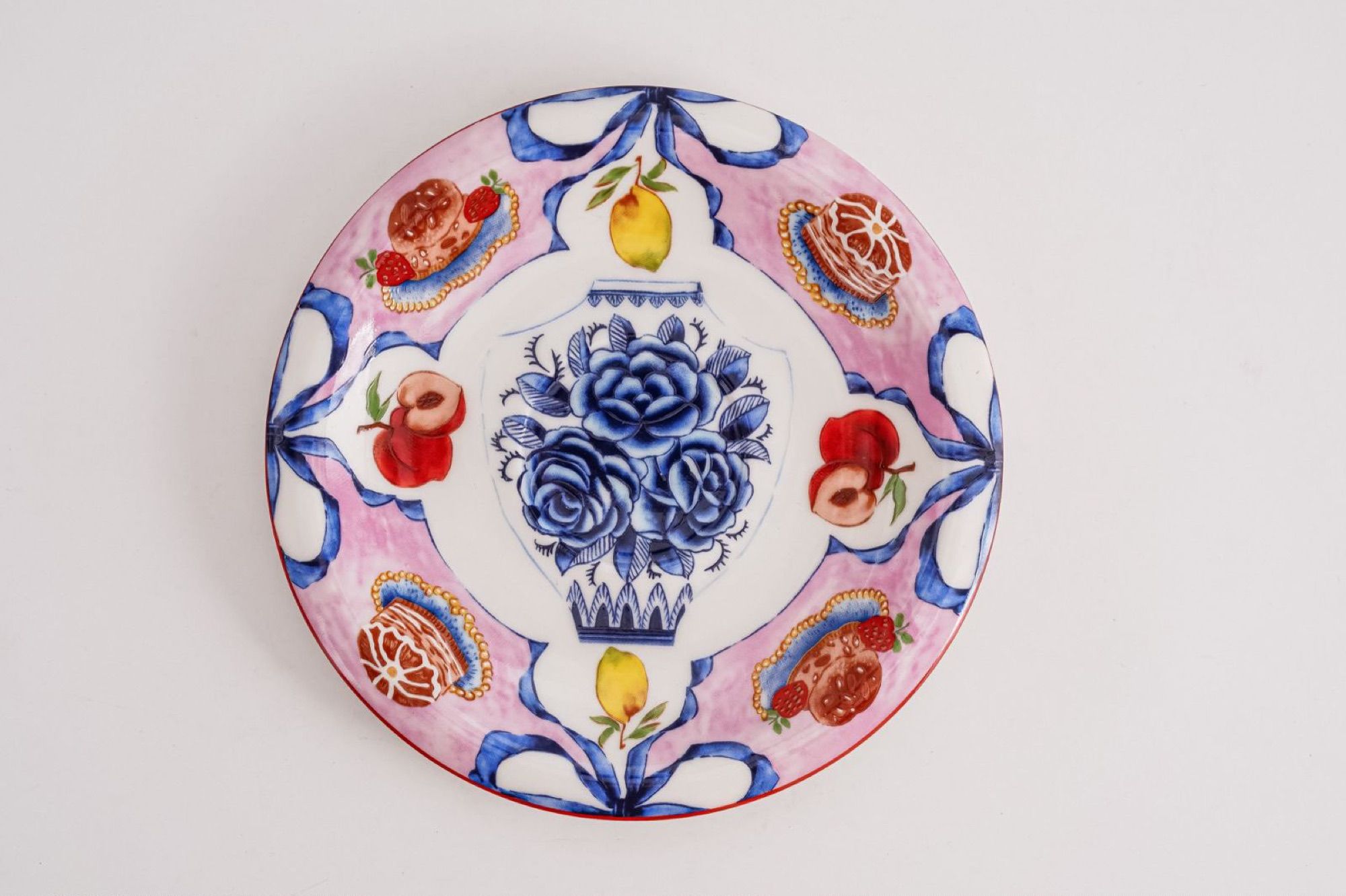 Top view of a decorated ceramic saucer showing the full pattern.