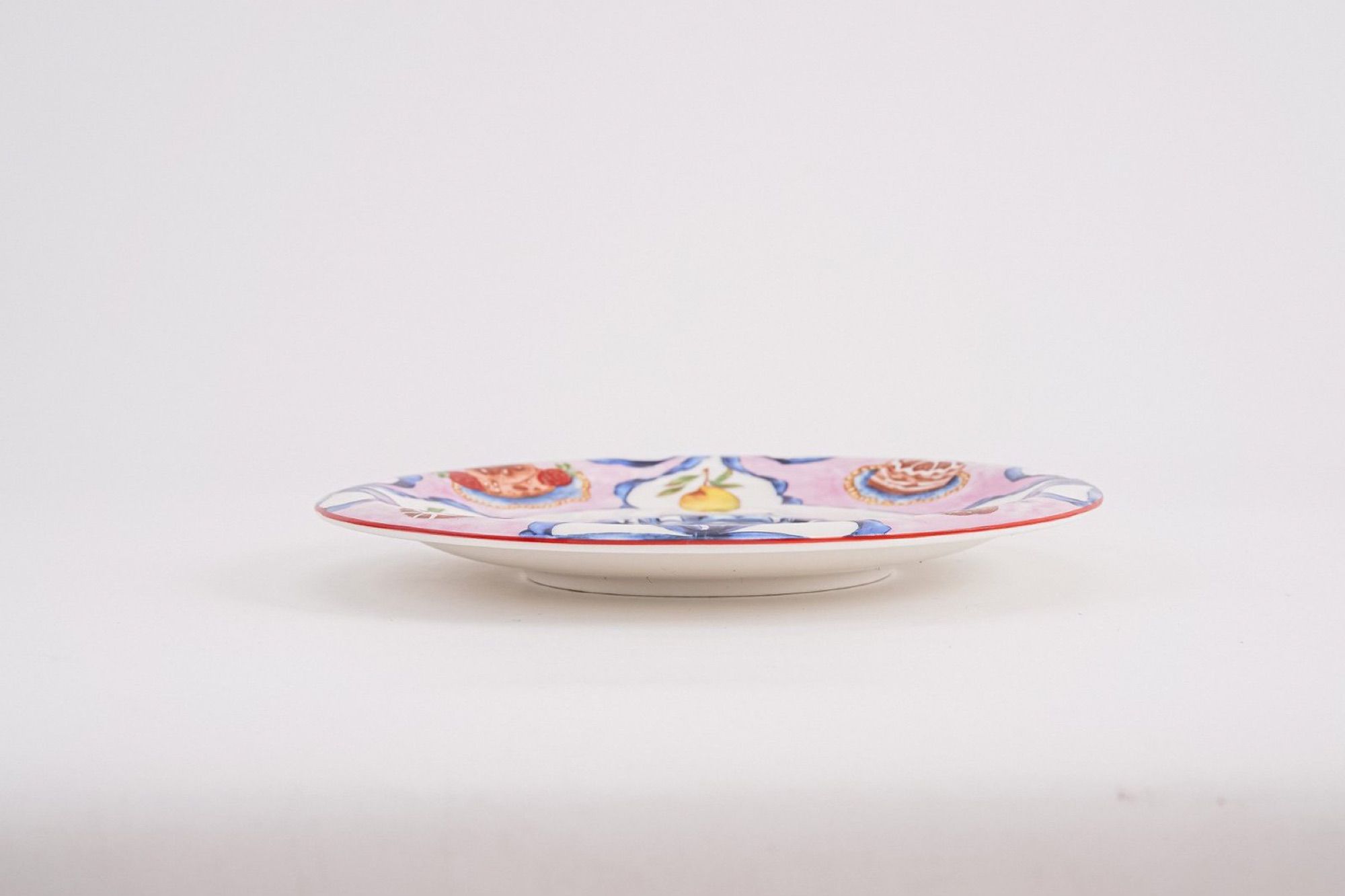 Side profile of the ceramic saucer against a plain background.
